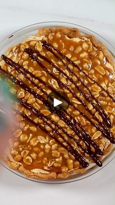 a dessert with chocolate drizzled on top and peanut butter in the middle