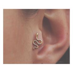 a close up of a person's ear with a snake on it