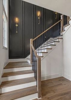 a staircase with black walls and wooden floors