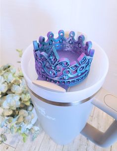 there is a cup with a purple crown on it