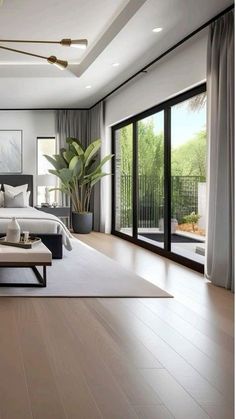 a modern bedroom with white walls and wood flooring, large window overlooking the backyard