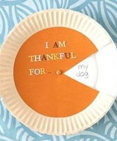 an orange and white paper plate with the words i am grateful for it on it