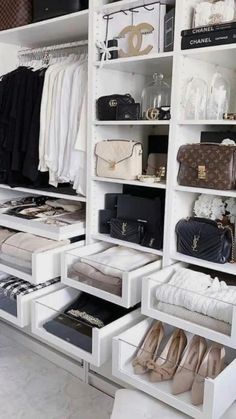 an organized closet with white shelves filled with purses and handbags