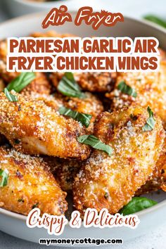 parmesan garlic air fryer chicken wings in a white bowl with herbs on top