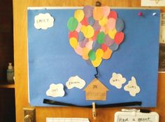 a bulletin board with a house shaped like a hot air balloon