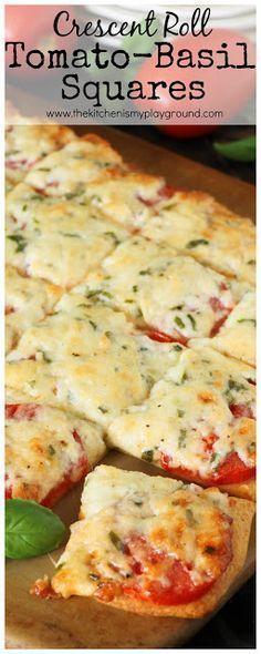 cheesy pesto - basil tomato and basil pizza with fresh basil leaves on the side