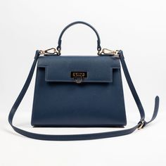 Layla Bag in Blue | Pebble Vegan Leather Bag – Levantine Blue Shoulder Bag With Round Handle For Evening, Luxury Navy Bags With Gold-tone Hardware, Modern Blue Top Handle Flap Bag, Timeless Shoulder Bag With Adjustable Top Handle, Timeless Shoulder Bag With Top Handle And Adjustable Strap, Blue Top Handle Flap Bag For Formal Occasions, Luxury Flap Tote Bag With Adjustable Handle, Elegant Top Handle Briefcase With Adjustable Strap, Office Top Handle Flap Bag With Detachable Handle