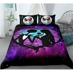 a bed covered in purple and black comforters