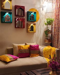 a living room filled with lots of furniture and colorful pillows on top of the couch