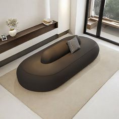 a modern living room with an oval shaped sofa