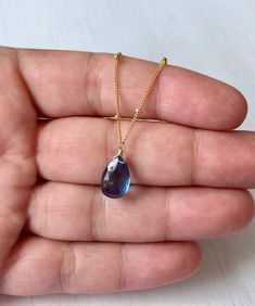 London Blue Topaz Necklace, December Birthstone, Navy Blue Teardrop Pendant, Silver Satellite Chain, Blue Layering Jewelry, Gift for her This simple dainty necklace features a london blue topaz teardrop suspended from a beautiful ball satellite chain in either gold filled or sterling silver. This blue topaz is very deep in color, navy royal blue which makes it match multiple outfit and could be your every day necklace since it is so neutral. This necklace is simply perfect for everyday wear and Blue Pear-shaped Birthstone Jewelry, Blue Topaz Drop Necklaces, Blue Drop Necklaces With Blue Topaz, Faceted Blue Topaz Blue Necklace, Blue Topaz Pear-shaped Necklace, Blue Drop Birthstone Jewelry, Blue Teardrop Pendant Necklace For Jewelry Making, Blue Teardrop Crystal Necklace For Gifts, Blue Drop Necklace For Gift