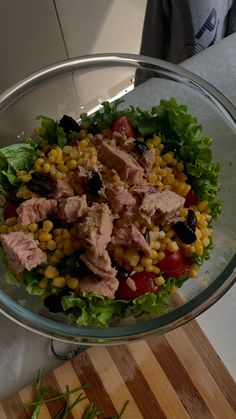 a glass bowl filled with corn and meat