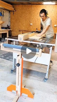 a man working on a table sawing in a garage with wood paneling and plywood