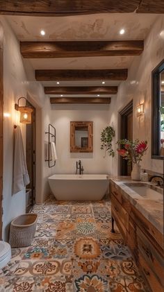 a bathroom with a bathtub, sink and toilet next to a wooden beamed ceiling