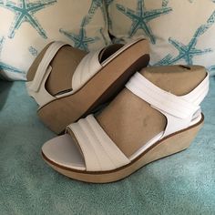 Brand New Never Worn White Pair Of Clark’s Wedge Sandals In Size 9. Both Straps Are Adjustable To Get The Right Fit. Wedge Is 2. 1/4” High. White Ankle Strap Wedge Sandals With Cushioned Footbed, Cushioned Medium Width Wedge Sandals For Beach, Spring Wedge Sandals With Ortholite Insole, White Wedge Sandals With Arch Support, White Wedge Heel Sandals With Arch Support, Medium Width Wedge Sandals For Beach, White Leather Wedge Sandals With Arch Support, Beach Wedge Sandals With Ortholite Insole And Open Toe, White Casual Wedge Sandals With Arch Support