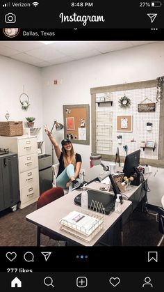 a woman sitting at a desk in front of a laptop computer with an instagram on the screen