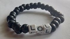 this bracelet is a black plastic beaded bracelet with plastic letter beaded that say lol it is on 1mm stretch magic string. this bracelet can be worn on a day to day basis but it is highly recommended that you don't wear this bracelet  while doing any sort of heavy activity or while sleeping to prevent any sort of breakage. Trendy Black Wristband With Letter Beads, Black Bracelets With Letter Beads, Adjustable Black Charm Bracelet With Letter Beads, Black Wristband With 8mm Beads, Adjustable Black Wristband With Letter Beads, Black Beaded Bracelet, Plastic Letters, Black Beaded Bracelets, Letter Beads