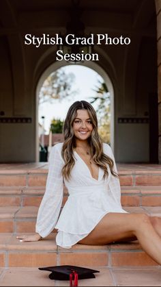 a woman is sitting on the steps with her graduation cap