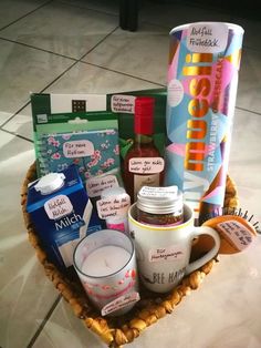 a basket filled with lots of different items on top of a table next to a cup