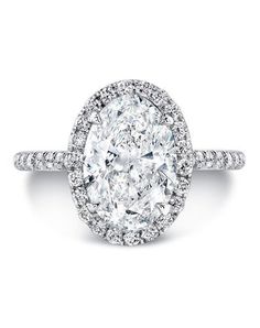 an oval cut diamond ring with pave set shoulders