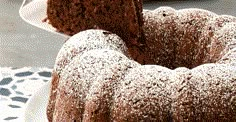 a chocolate bundt cake with powdered sugar on top and one slice being taken out