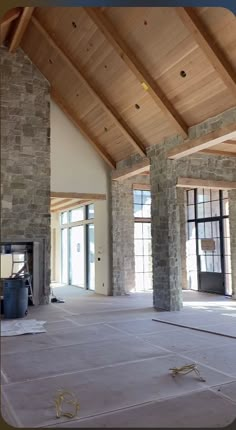 an empty room with stone pillars and windows