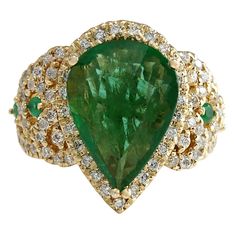 Immerse yourself in the mesmerizing allure of this Emerald Diamond Ring, a true testament to timeless elegance and luxury. Crafted in radiant 14K Yellow Gold and weighing a substantial 9.7 grams, this ring boasts a remarkable 8.00 carats of celestial beauty. At its heart lies a captivating 6.00 carat Emerald, measuring an impressive 15.80x11.00 millimeters. The Emerald's rich green hue captivates the eye and exudes natural allure. Surrounding the Emerald exquisite diamonds totaling 2.00 carats. Yellow Gold Diamond Ring, Emerald Diamond Ring, Gold Diamond Ring, Classy Jewelry, Jewelry Tree, Green Diamond, Lovely Ring, Gorgeous Jewelry, Gold Diamond Rings