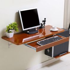 a computer monitor sitting on top of a wooden desk next to a keyboard and mouse