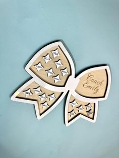 two wooden magnets with words and stars on them, one is for each family