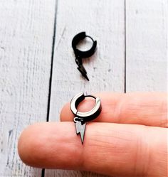 14 mm diameter ring made of satin black stainless steel, the earring ring is 4 mm thick, the beam is 10 mm long, and the closure is clip-on. A design in which the central motif is the lightning bolt, hypnotic, enclosed in its darkness. A symbol represented continuously for centuries. A model that can be easily combined with other designs in stainless steel and black silver from our catalog. When buying jewelry in contact with the skin, it is important that the materials, the steel, silver and th Black Stainless Steel Hoop Earrings, Modern Black Stainless Steel Hoop Earrings, Minimalist Black Stainless Steel Hoop Earrings, Black Stainless Steel Hoop Jewelry, Black Hypoallergenic Hoop Earrings In Stainless Steel, Black Small Hoop Earrings Internally Threaded, Gift Black Internally Threaded Hoop Earrings, Edgy Black Stainless Steel Earrings, Black Stainless Steel Hoop Earrings As Gift