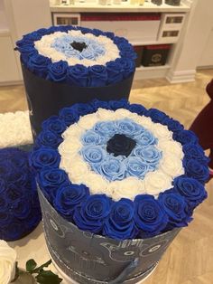 three large blue and white roses are stacked on top of each other in a box