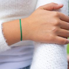 Step into a world of balance and well-being with our Green Adjustable Cord Bracelet. This unique accessory is not just a piece of jewelry; it symbolizes prosperity, health, and progress. Made from high-quality material, it's designed to last years while offering comfort and style. The rich green color, known for attracting prosperity and abundance, also embodies courage and confidence. Wearing this bracelet stabilizes your aura, bringing harmony and protecting against negative forces. Soft, comf Adjustable Cord Bracelet, Prosperity Bracelet, Ribbon Bracelet, Prosperity And Abundance, Bracelet Pack, Ribbon Bracelets, Color Meanings, Rich Green, Cord Bracelet