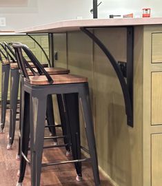 the bar stools are next to the counter in the kitchen