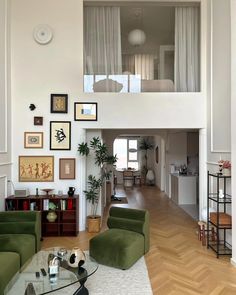 a living room filled with furniture and pictures on the wall