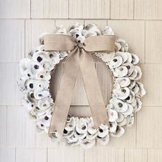 a wreath made out of shells with a bow