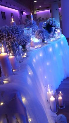 the table is set with candles and flowers