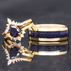 two gold rings with blue and white stones on them, one is set in yellow gold