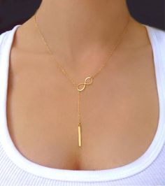 Vertical Bar Lariat Necklace  This sophisticated lariat necklace exudes luminous polish. Perfect for wearing alone or layering with other necklaces.  Vertical b Minimalist Lariat Necklace For Gift, Adjustable Gold Lariat Necklace For Gift, Gold Dangle Lariat Necklace For Gift, Gold Dangle Lariat Necklace Gift, Modern Lariat Necklace With Clavicle Chain As Gift, Gold Sterling Silver Lariat Necklace With Adjustable Chain, Minimalist Gold Y-shape Lariat Necklace, Gold Long Drop Lariat Necklace Gift, Gold Sterling Silver Lariat Necklace