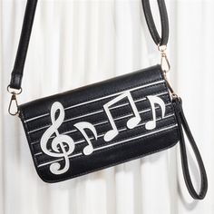 a black purse with musical notes on it