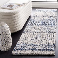 a white and blue rug in a living room