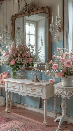 there are flowers in vases on the table and an ornate mirror behind them,