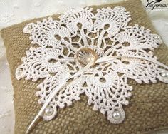 a close up of a piece of cloth with a lace doily and button on it