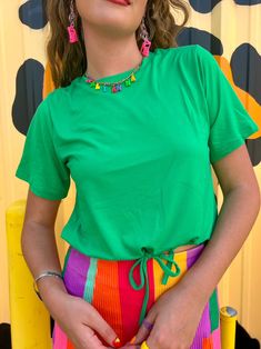 Wear your joy with the Joyful Green Drawstring top! You will love this top for its effortless style, drawstring bottom that gives you flexibility on how you style it, and of course the fun Kelly green color! This top is roomy for its size so we recommend sizing down if between sizes and if you want a more snug fit. Adjustable drawstring Fun Kelly Green color Breezy fit to beat the summer heat Slightly cropped so it is great with high-waisted bottoms True to size 92% Polyester 8% spandex Kate is Drawstring Top, Neutral Outfit, Summer Heat, Kelly Green, Hat Hairstyles, Tee Shop, Skirt Pants, Of Course, Sweater Jacket