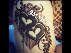 a woman's thigh with an intricate tattoo design on the side and heart in the middle