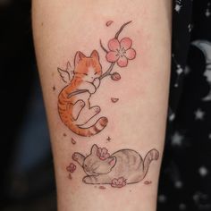 a cat and mouse tattoo on the arm