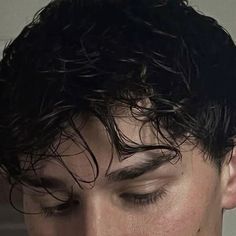 a close up of a person with his eyes closed and wet hair in the wind