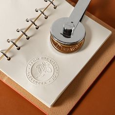 an open notebook with a pen on top of it and the logo for the university of florida