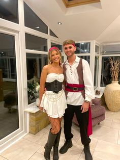 a man and woman dressed up in pirate costumes