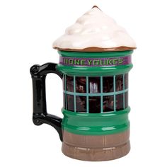 a green and brown coffee mug with a white frosting on it's top