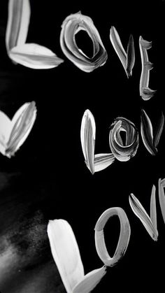 the words love spelled with white paint on a black background